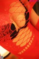 A close up of a woman in a red lingerie.