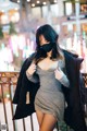 A woman wearing a face mask standing on a bridge.