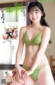 a japanese woman in a green bikini posing for the camera