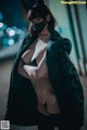 A woman wearing a cat mask and a black jacket.