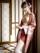 A woman in a kimono is posing for the camera.